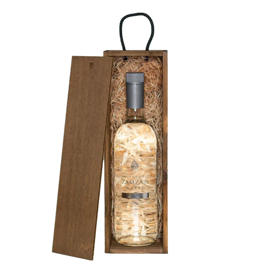 Zamzam bottled water in premium see-through glass contained within wooden gift box aerial shot from directly above
